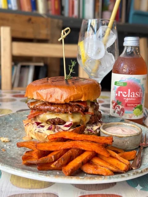 a plant-based burger and sweet potato fries at cookaluzka, madrid